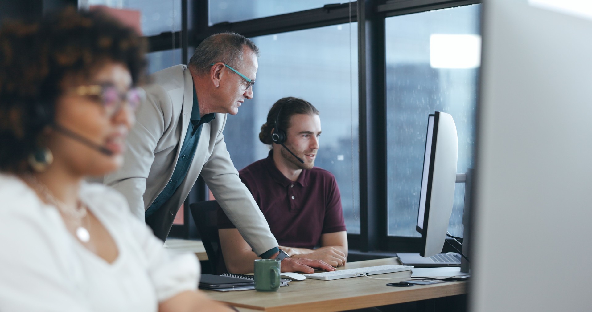 Call center, consulting and coaching with man in office for customer service, technical support and help desk. Telemarketing, contact us and mentor with employee for training, teamwork or advice